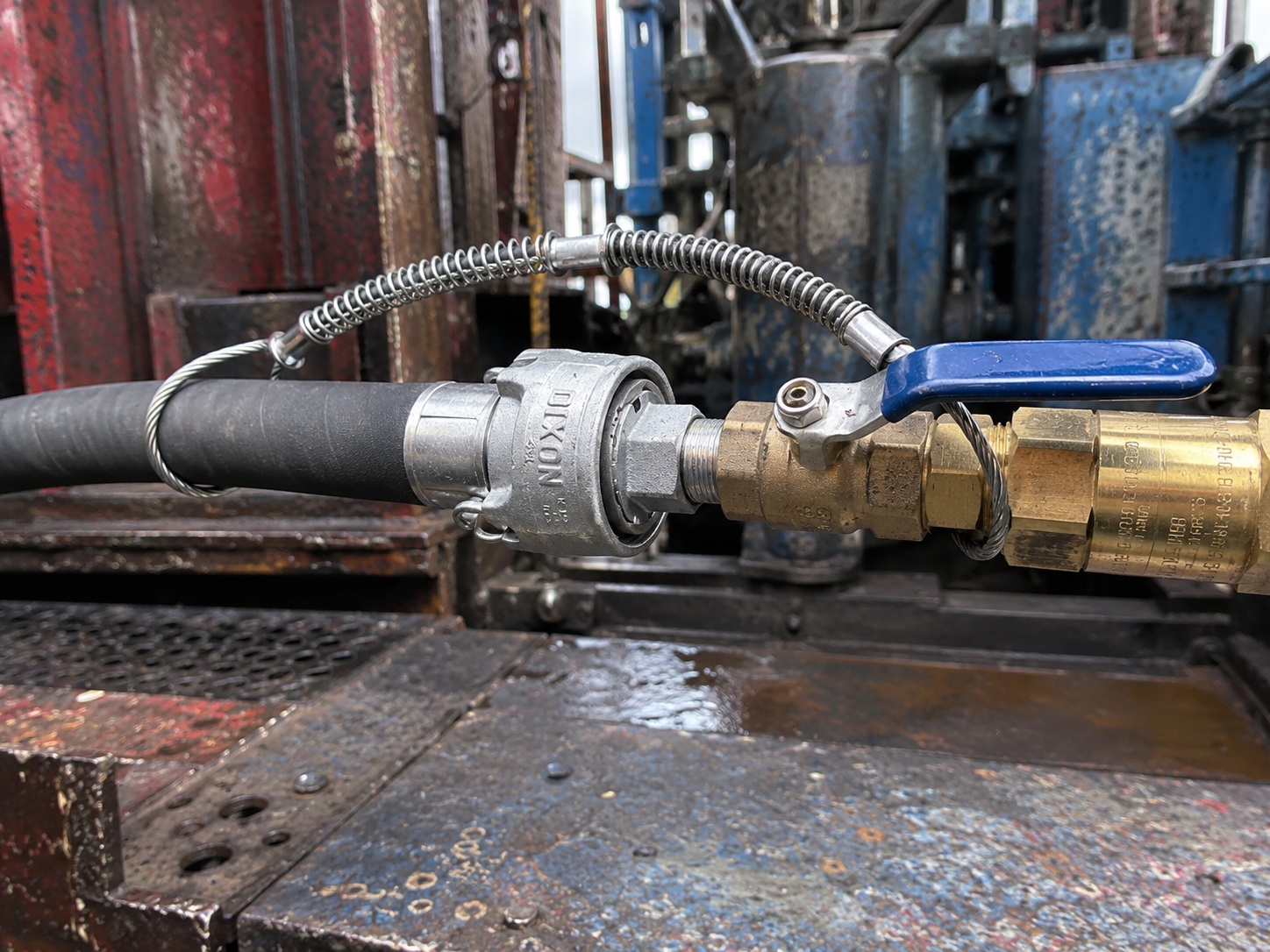 Oilfield hose safety cable installed on high pressure hose connection